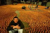 British artist Antony Gormley sits among the 180,000 figurines that make up Asian Field, part of the Sydney Biennale.